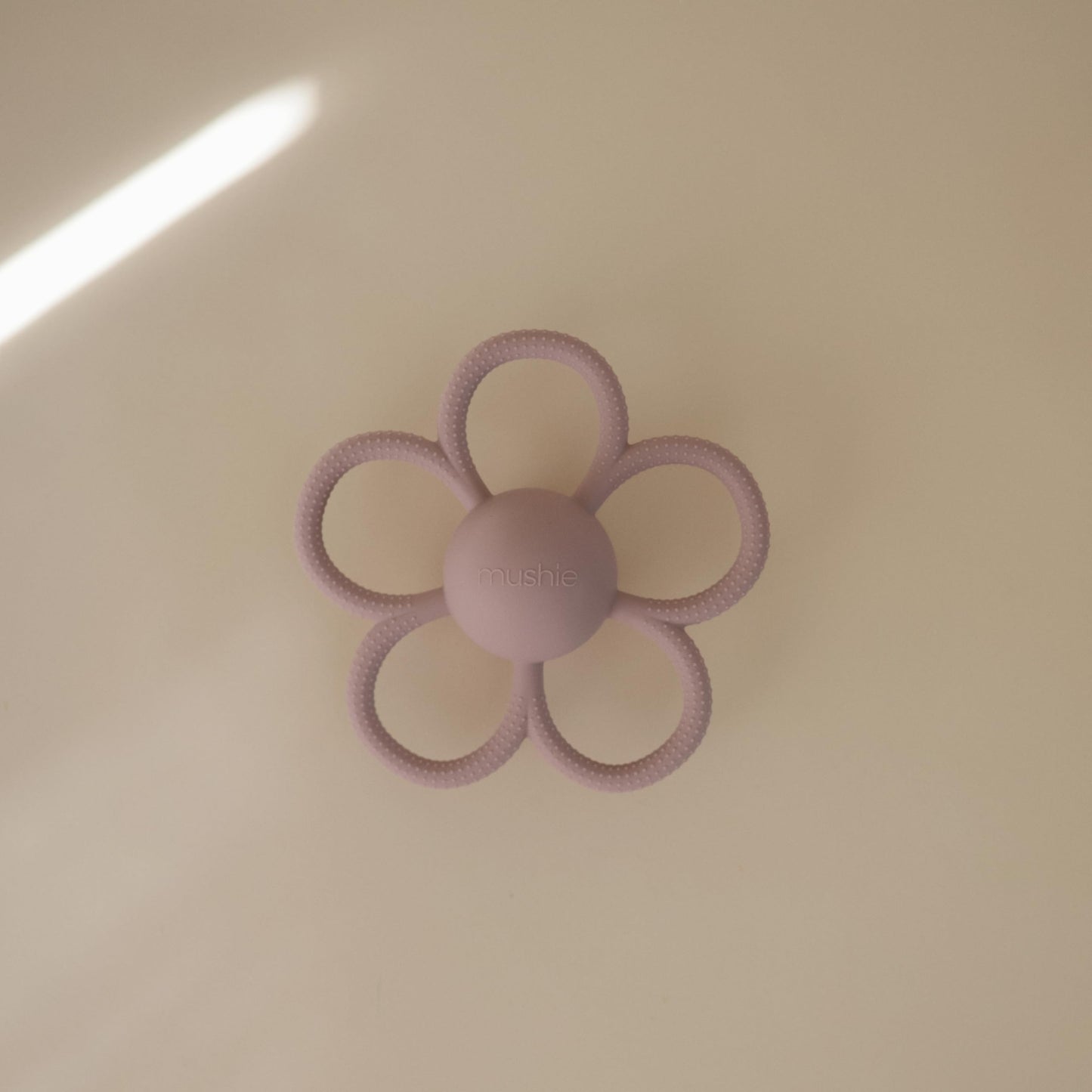 mushie Silicone Baby Daisy Rattle Teether Toy (Soft Lilac)