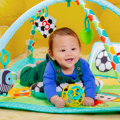Bright Starts Grip & Kick Oball Activity Gym, Soccer Theme with Easy-Grasp Baby Toys, Baby Play Gym, Kick Pad with Activated Lights & Tummy Time Pillow, Unisex, Newborn+